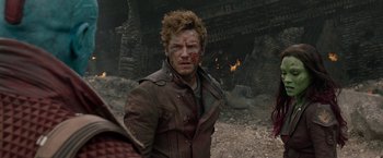 Movie still from “Guardians of the Galaxy” (2014), directed by James Gunn – A man in a brown leather jacket with a knife in his mouth; Close Up shot, Over the shoulder angle