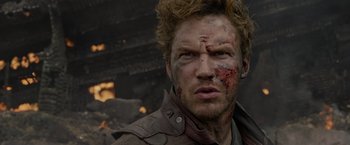 Movie still from “Guardians of the Galaxy” (2014), directed by James Gunn – A person wearing a jacket with blood all over his face; Close Up shot, Over the shoulder angle