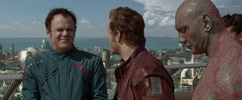 Movie still from “Guardians of the Galaxy” (2014), directed by James Gunn – Two men are standing in front of a city; Close Up shot, Over the shoulder angle