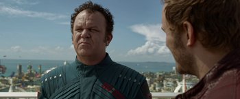 Movie still from “Guardians of the Galaxy” (2014), directed by James Gunn – A man in a green jacket looking at another man in a blue jacket; Close Up shot, Over the shoulder angle