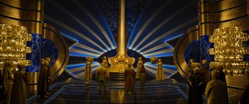 Movie still from “Guardians of the Galaxy Vol. 2” (2017), directed by James Gunn – A group of people standing in front of a large sculpture; Extreme Wide shot, Low angle