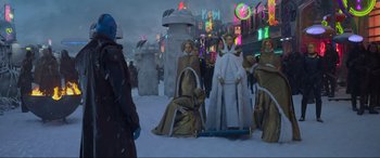 Movie still from “Guardians of the Galaxy Vol. 2” (2017), directed by James Gunn – A group of people dressed in costumes in the middle of a street; Wide shot, Over the shoulder angle