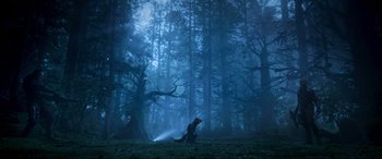 Movie still from “Guardians of the Galaxy Vol. 2” (2017), directed by James Gunn – A person in the middle of a forest with a light shining on them; Extreme Wide shot, Low angle