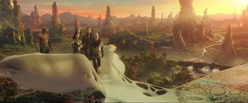 Movie still from “Guardians of the Galaxy Vol. 2” (2017), directed by James Gunn – Three people standing on top of a hill with trees in the background; Wide shot, Overhead angle