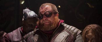 Movie still from “Guardians of the Galaxy Vol. 2” (2017), directed by James Gunn – A person with a beard wearing sunglasses; Close Up shot, Low angle