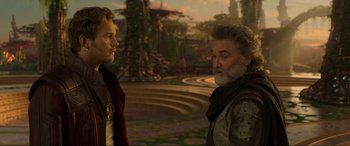 Movie still from “Guardians of the Galaxy Vol. 2” (2017), directed by James Gunn – Two men standing next to each other in a park; Medium shot, Over the shoulder angle