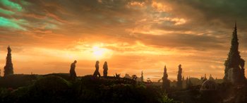 Movie still from “Guardians of the Galaxy Vol. 2” (2017), directed by James Gunn – Three people are walking on a hill at sunset; Extreme Wide shot, Low angle