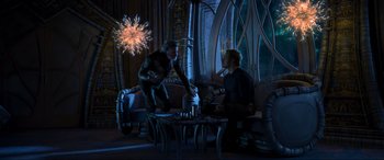 Movie still from “Guardians of the Galaxy Vol. 2” (2017), directed by James Gunn – Two people sitting on a couch in a living room; Wide shot, Over the shoulder angle