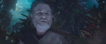 Movie still from “Guardians of the Galaxy Vol. 2” (2017), directed by James Gunn – An old man with a beard and a mustache is looking at the camera; Close Up shot, Low angle