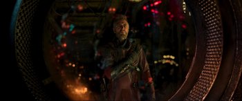 Movie still from “Guardians of the Galaxy Vol. 2” (2017), directed by James Gunn – A man in a red suit holding a gun; Medium shot, Over the shoulder angle