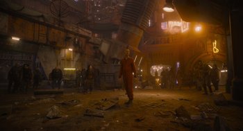 Movie still from “Guardians of the Galaxy Vol. 3” (2023), directed by James Gunn – A man in a red suit is walking in the middle of an abandoned city; Extreme Wide shot, Low angle