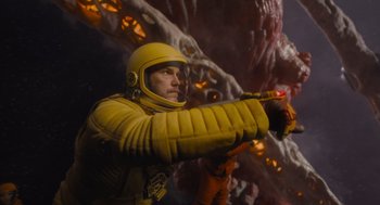 Movie still from “Guardians of the Galaxy Vol. 3” (2023), directed by James Gunn – A man in a yellow space suit holding a red object; Medium shot, Low angle