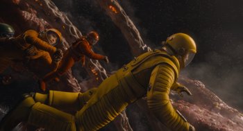 Movie still from “Guardians of the Galaxy Vol. 3” (2023), directed by James Gunn – A scene of a space scene with a man in yellow and a man in orange; Wide shot, Overhead angle