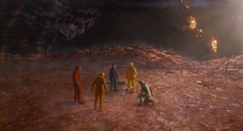 Movie still from “Guardians of the Galaxy Vol. 3” (2023), directed by James Gunn – A group of people standing on top of a dirt field; Extreme Wide shot, High angle