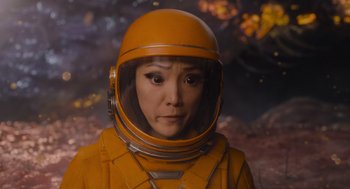 Movie still from “Guardians of the Galaxy Vol. 3” (2023), directed by James Gunn – A woman in an orange space suit and helmet; Close Up shot, High angle