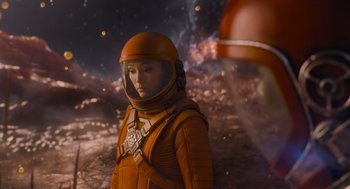 Movie still from “Guardians of the Galaxy Vol. 3” (2023), directed by James Gunn – A woman in a space suit standing in front of an asteroid field; Medium shot, Over the shoulder angle