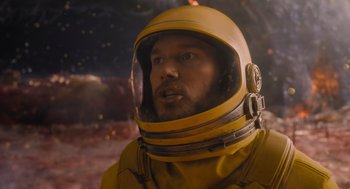 Movie still from “Guardians of the Galaxy Vol. 3” (2023), directed by James Gunn – A man wearing a yellow space suit and a helmet; Close Up shot, Over the shoulder angle