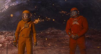 Movie still from “Guardians of the Galaxy Vol. 3” (2023), directed by James Gunn – A couple of people that are standing in the dirt; Medium shot, Overhead angle