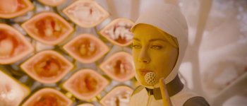 Movie still from “Guardians of the Galaxy Vol. 3” (2023), directed by James Gunn – A woman in a white lab coat holding a raspberry; Close Up shot, Over the shoulder angle