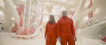 Movie still from “Guardians of the Galaxy Vol. 3” (2023), directed by James Gunn – A man and a woman dressed in red standing next to each other; Wide shot, Low angle