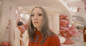 Movie still from “Guardians of the Galaxy Vol. 3” (2023), directed by James Gunn – A woman in a red shirt with two antennas on her head; Close Up shot, Low angle