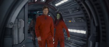 Movie still from “Guardians of the Galaxy Vol. 3” (2023), directed by James Gunn – A man and a woman dressed in red and green; Medium shot, Over the shoulder angle