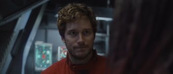 Movie still from “Guardians of the Galaxy Vol. 3” (2023), directed by James Gunn – A person with curly hair; Close Up shot, Over the shoulder angle