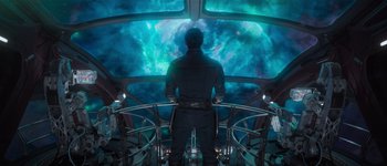 Movie still from “Guardians of the Galaxy Vol. 3” (2023), directed by James Gunn – A man standing in front of a large window; Medium shot, Low angle