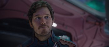 Movie still from “Guardians of the Galaxy Vol. 3” (2023), directed by James Gunn – A person wearing a suit; Close Up shot, Over the shoulder angle