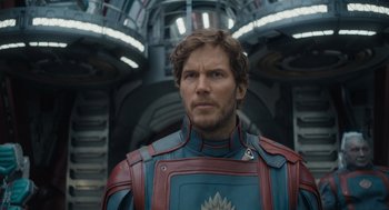 Movie still from “Guardians of the Galaxy Vol. 3” (2023), directed by James Gunn – A man wearing a suit of armor in a building; Close Up shot, Over the shoulder angle