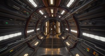 Movie still from “Guardians of the Galaxy Vol. 3” (2023), directed by James Gunn – A man standing inside of an industrial building; Extreme Wide shot, Overhead angle