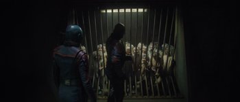 Movie still from “Guardians of the Galaxy Vol. 3” (2023), directed by James Gunn – A group of people standing in front of a jail cell; Wide shot, High angle