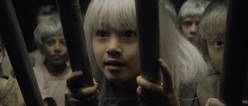 Movie still from “Guardians of the Galaxy Vol. 3” (2023), directed by James Gunn – A young girl with white hair looking at the camera; Close Up shot, High angle