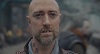 Movie still from “Guardians of the Galaxy Vol. 3” (2023), directed by James Gunn – A man with a shaved head and a beard; Close Up shot, Over the shoulder angle