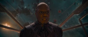 Movie still from “Guardians of the Galaxy Vol. 3” (2023), directed by James Gunn – A man in a black suit is looking at the camera; Close Up shot, Low angle