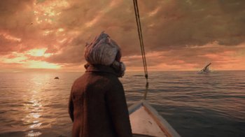 Movie still from “Guillermo del Toro's Pinocchio” (2022), directed by Guillermo del Toro – A person on a sailboat in the ocean at sunset; Extreme Wide shot, Low angle