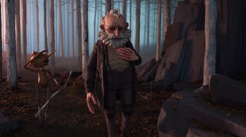 Movie still from “Guillermo del Toro's Pinocchio” (2022), directed by Guillermo del Toro – An old man with a beard is standing in the woods; Wide shot, Over the shoulder angle