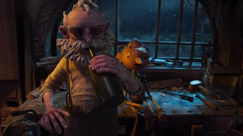 Movie still from “Guillermo del Toro's Pinocchio” (2022), directed by Guillermo del Toro – A man with a beard drinking a drink next to another man with a beard; Wide shot, Low angle