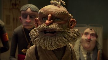 Movie still from “Guillermo del Toro's Pinocchio” (2022), directed by Guillermo del Toro – The face of a statue of a man with a long beard; Close Up shot, Low angle