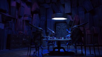 Movie still from “Guillermo del Toro's Pinocchio” (2022), directed by Guillermo del Toro – A group of people sitting at a table in the dark; Wide shot, Over the shoulder angle