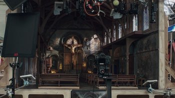 Movie still from “Guillermo del Toro's Pinocchio” (2022), directed by Guillermo del Toro – A camera is set up to take a picture in a church; Extreme Wide shot, High angle