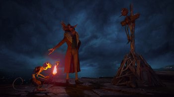 Movie still from “Guillermo del Toro's Pinocchio” (2022), directed by Guillermo del Toro – An image of an evil looking demon with a fire in the background; Wide shot, Low angle