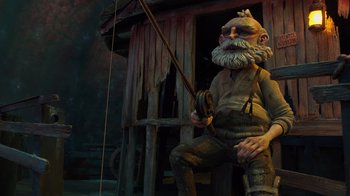 Movie still from “Guillermo del Toro's Pinocchio” (2022), directed by Guillermo del Toro – A statue of a man holding a fishing pole; Wide shot, Low angle