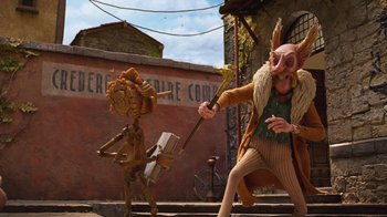 Movie still from “Guillermo del Toro's Pinocchio” (2022), directed by Guillermo del Toro – A man and a woman dressed in costumes; Wide shot, Low angle