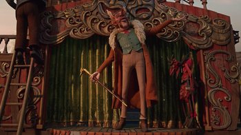 Movie still from “Guillermo del Toro's Pinocchio” (2022), directed by Guillermo del Toro – A statue of a man with a beard and a cane; Wide shot, Low angle