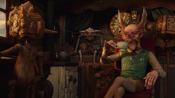 Movie still from “Guillermo del Toro's Pinocchio” (2022), directed by Guillermo del Toro – A man sitting in a chair drinking a cup of coffee; Wide shot, Over the shoulder angle