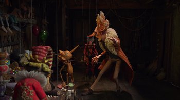 Movie still from “Guillermo del Toro's Pinocchio” (2022), directed by Guillermo del Toro – A group of people standing next to each other on a stage; Wide shot, Low angle