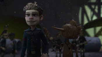 Movie still from “Guillermo del Toro's Pinocchio” (2022), directed by Guillermo del Toro – A cartoon of a boy and a wooden creature; Medium shot, Over the shoulder angle
