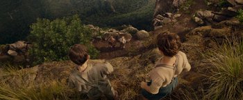 Movie still from “Hacksaw Ridge” (2016), directed by Mel Gibson – Two children looking at a herd of goats on a hillside; Extreme Wide shot, Overhead angle