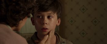 Movie still from “Hacksaw Ridge” (2016), directed by Mel Gibson – A young boy with his hand under his chin; Close Up shot, Over the shoulder angle